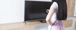 © Artvibe - the girl watches TV and holds a remote control in her hands