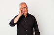 © Asier - Senior american man isolated on white background with fingers on lips keeping a secret.