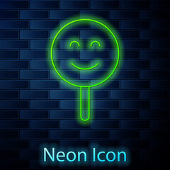 Wall Mural - Glowing neon line Smile face icon isolated on brick wall background. Smiling emoticon. Happy smiley chat symbol. Vector