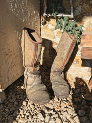 Old dirty vintage military boots, Shoes of the 1930- 1940s. Men's vintage shoes. Old leather and felt  shoes.