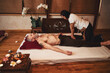 Grizzled lean male during thai massage in studio