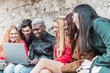 © ADDICTIVE STOCK - Group of multiracial friends gathering around laptop