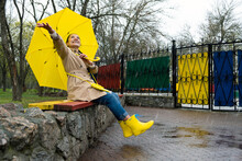 Happy Older Women Having Fun Outdoor. Senior Cheerful Mature Elderly Retired Woman With Yellow Umbrella Enjoying Life At Rainy Day In Park. Enjoying Life, Positive Emotions, Happy Retirement
