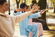 Women Standing On One Leg During Tai Chi Lesson