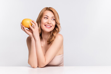 Poster - Portrait of attractive cheerful woman wearing nude top holding citrus weightloss fit menu isolated over grey pastel color background