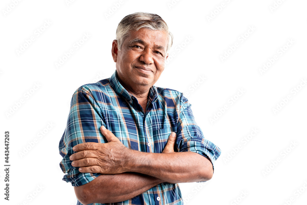 Portrait of handsome senior man standing with his arms crossed in ...