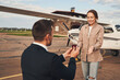 Man in love making proposal to his girlfriend at airdrome