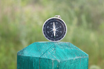classic navigation compass on natural background as symbol of tourism with compass, travel with comp