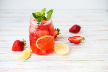 Cold Summer Strawberry Lemonade In A Jar On A White Background, Selective Focus