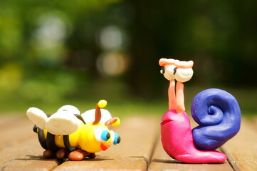 Sticker - Figure of a snail and a bee close-up. A symbol of spring and summer.