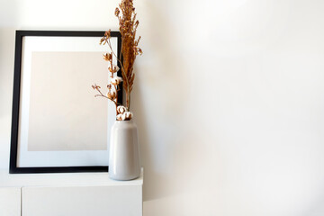 Wall Mural - Empty wooden photo,picture frame mock-up with white vase and stylish plant near white wall on table, Copy space modern decoration interior