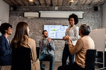 Group of diverse group of business people having a meeting while sitting in circle.