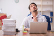 © Elnur - Young male employee and too much work in the office