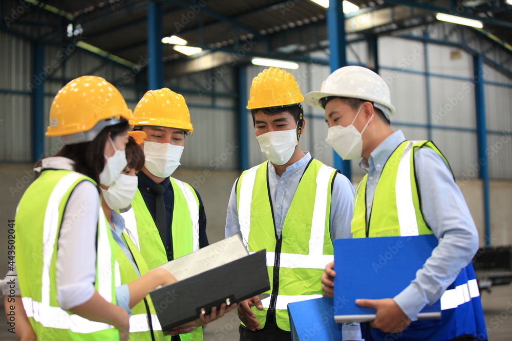 Team workers wear protective face masks for safety industrial factory. worker meeting before start working in factory or warehouse - obrazy, fototapety, plakaty 