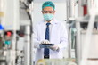 © sittinan - Production engineer with face mask working in factory , Qc engineer checking mask for good quality , Concept of protective action and quarantine to stop spreading of Coronavirus Disease 2019