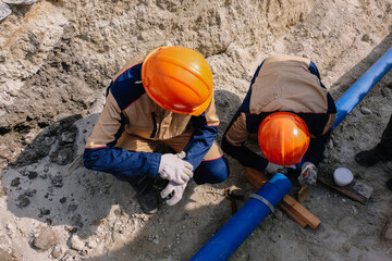 Workers are installing water supply pipeline system