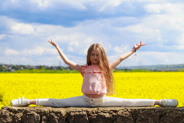 smiling teenage child sitting on a twine. health concept. girl in nature, lifestyle.