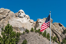 American Flag Waiving In Front Of Mount Rushmore