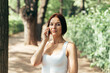 © gesrey - Girl talking thoughtfully on a smartphone while walking in the park