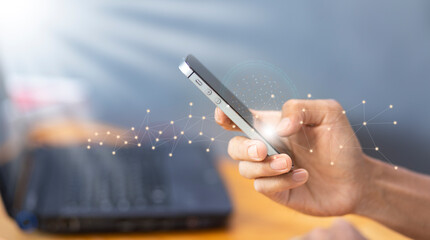 Wall Mural - connection and  communication concept with man hand using mobile smartphone with network and blue copy space background