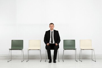 Poster - Man with clipboard waiting for job interview in office hall