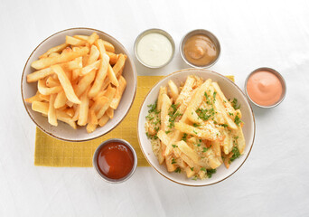 deep fried golden French fries with parmesan cheesy sauce in white background western snack cuisine halal fast food menu