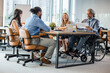 © Dragana Gordic - Portrait of smiling disabled business executive in wheelchair at meeting. Paralyzed man in a wheelchair. Shot of a team of businesspeople having a meeting in a modern office.
