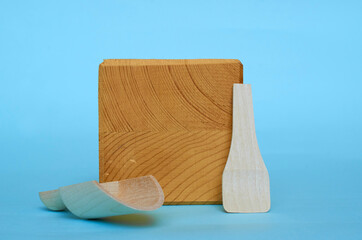 Two wooden spoons and a wooden square blank with a place for text