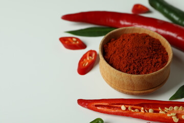 Poster - Red and green peppers and powder on white background