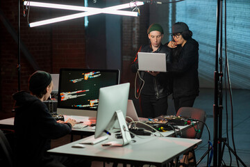 several hackers breaking secret information in front of computers