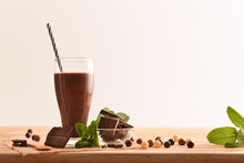 Glass With Milk Chocolate Shake On Wooden Table Isolated Background
