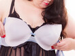 Woman plus size holding bra