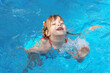 © Елена Гурова - little girl swims in a swimming pool with blue water