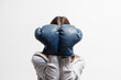 © Natali - Woman close her face by the boxing gloves close up on the white background.