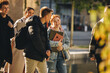 © Jacob Lund - Smiling girl walking with friends in high school