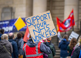 Fototapeta Na ścianę - Support your NHS workers at protest rally holding home made placard sign to gain support for NHS key worker staff on march.