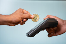 Concept Showing Of Cryptocurrency Payment - Hands Paying Buy Placing On Swiping Payment Machine.