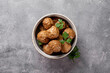  Traditional swedish meatballs in a bowl on gray background top view