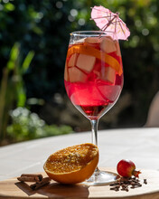 A Tasty Glass Of Sangria With Pieces Of Fruit Inside In Backlight