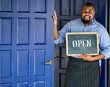 © Rawpixel.com - A cheerful small business owner with open sign