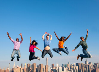 Poster - Group of multi racial people jumping in the city.