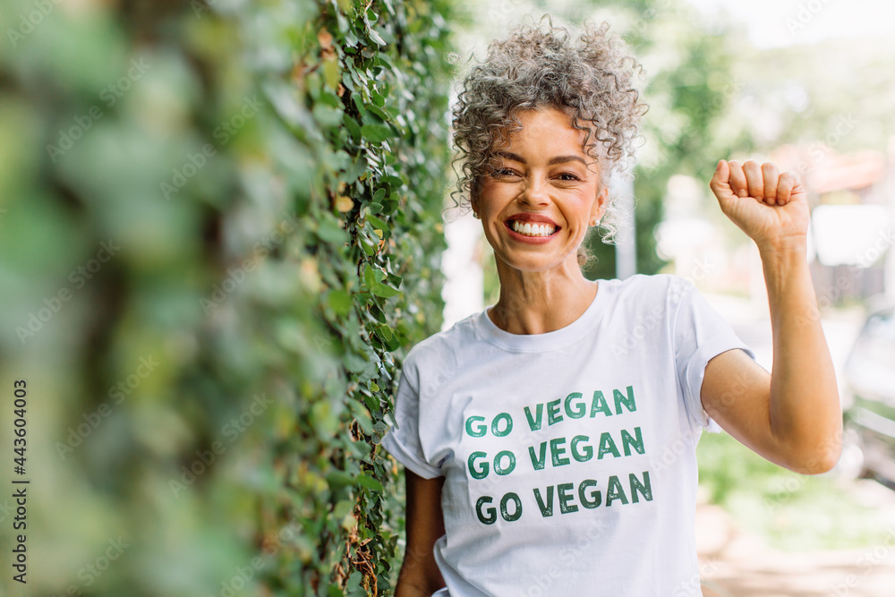 Smiling vegan activist advocating for veganism - obrazy, fototapety, plakaty 