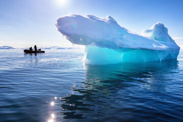 Wall Mural - blue ice iceberg in nordfjorden, svalbard, with the sun shining through