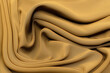 Silk chiffon fabric sand and brown color  in artistic layout. Texture, background, pattern.