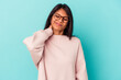 © Asier - Young latin woman isolated on blue background having a neck pain due to stress, massaging and touching it with hand.