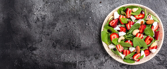 Wall Mural - Summer Fruit Strawberry, spinach Salad with nuts, feta cheese balsamic vinegar, Detox and healthy superfoods concept. banner, menu, recipe place for text, top view