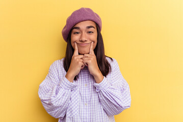 Wall Mural - Young mixed race woman isolated on yellow background doubting between two options.