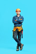 © GVS - Full length portrait of confident handsome male construction worker with crossed arms
