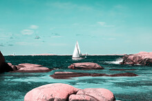 Sailboats On Rock By Sea Against Sky