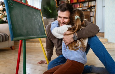 Wall Mural - Happy father and his daughter spending quality time together at home